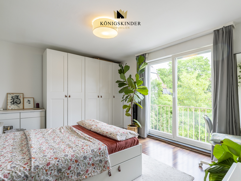 Helles Schlafzimmer mit großem Fenster und freundlichem Raumgefühl